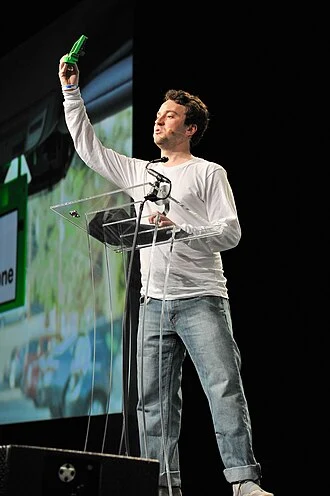 Portrait of George Hotz, a young entrepreneur and hacker known for his work in the tech industry.